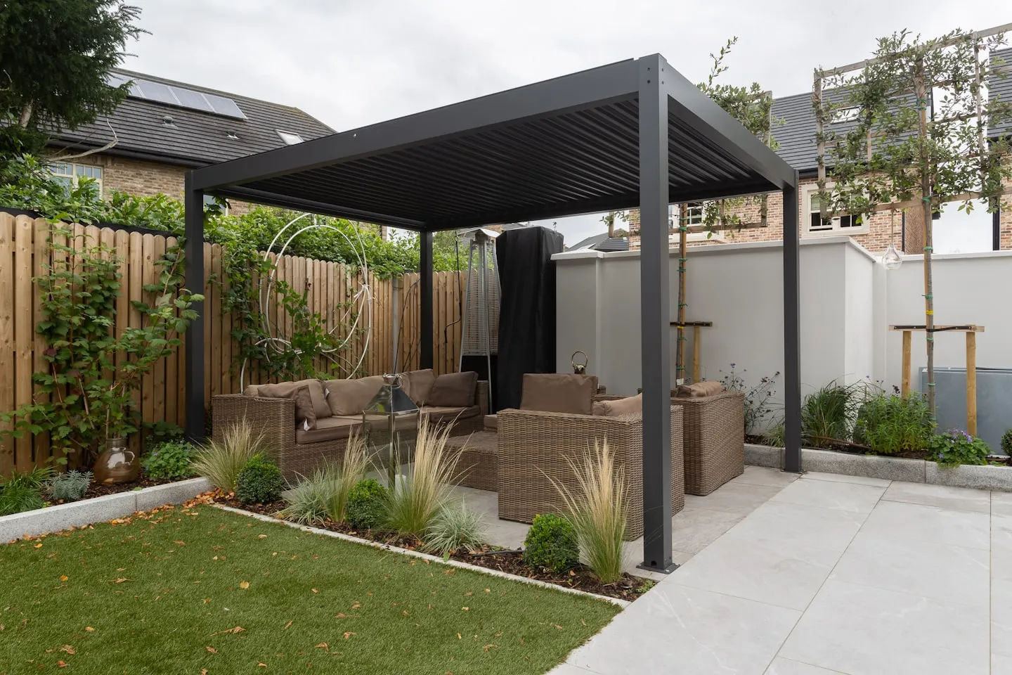 Contemporary garden pergola providing shade over a decked seating area