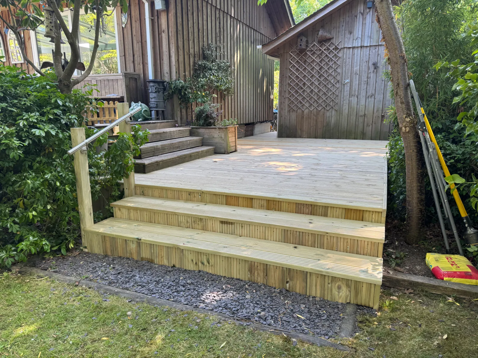 Timber decking kept pristine with minimal upkeep in a family garden